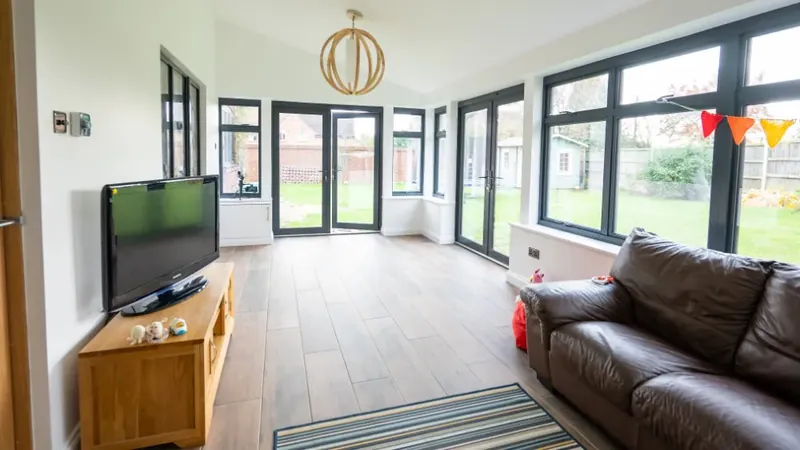 Single storey side and rear extension with grey cladding and aluminium windows on a detached house in Elmsett, Suffolk